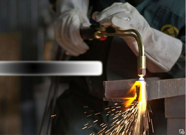 Metal processing worker using cutting tool with sparks flying